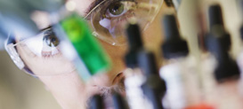 Animal science laboratory technician looking at vials.