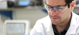 A Molecular & Cell Biology & Genetics program graduate student working in a laboratory at Drexel University College of Medicine.