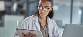 Doctor using a digital tablet at work.