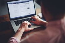 A person working on a laptop.