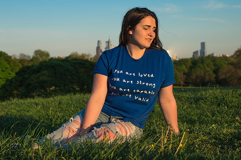 Gabby Frost in a Buddy Project shirt she designed. Photo credit Lexi Shannon.