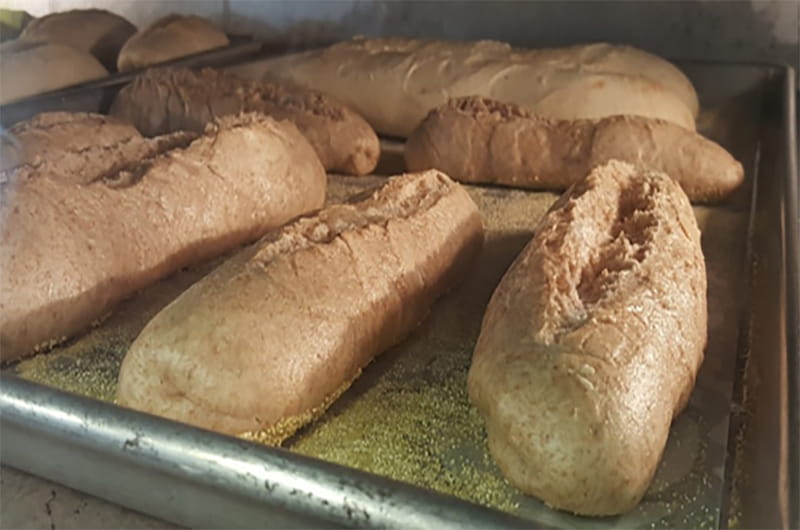 Lower-sodium hoagie rolls baking in oven.