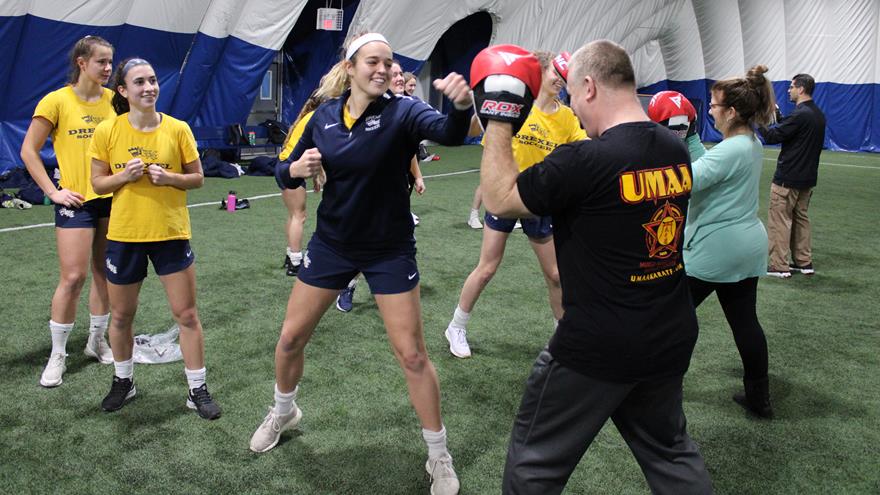 A group of students sparring in a self-defense class.