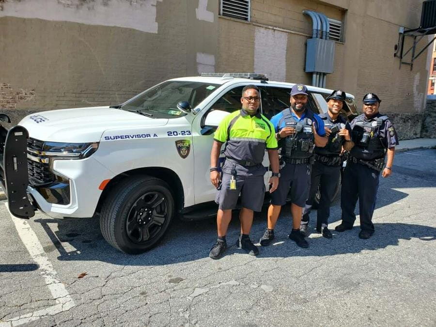 DUPC posing in front of police vehicle