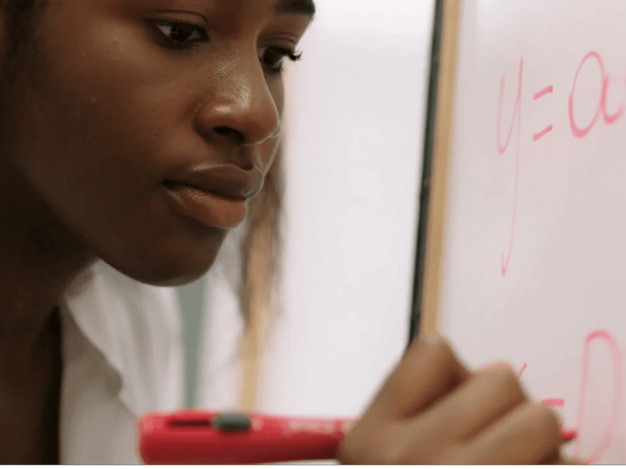 Woman working at whiteboard