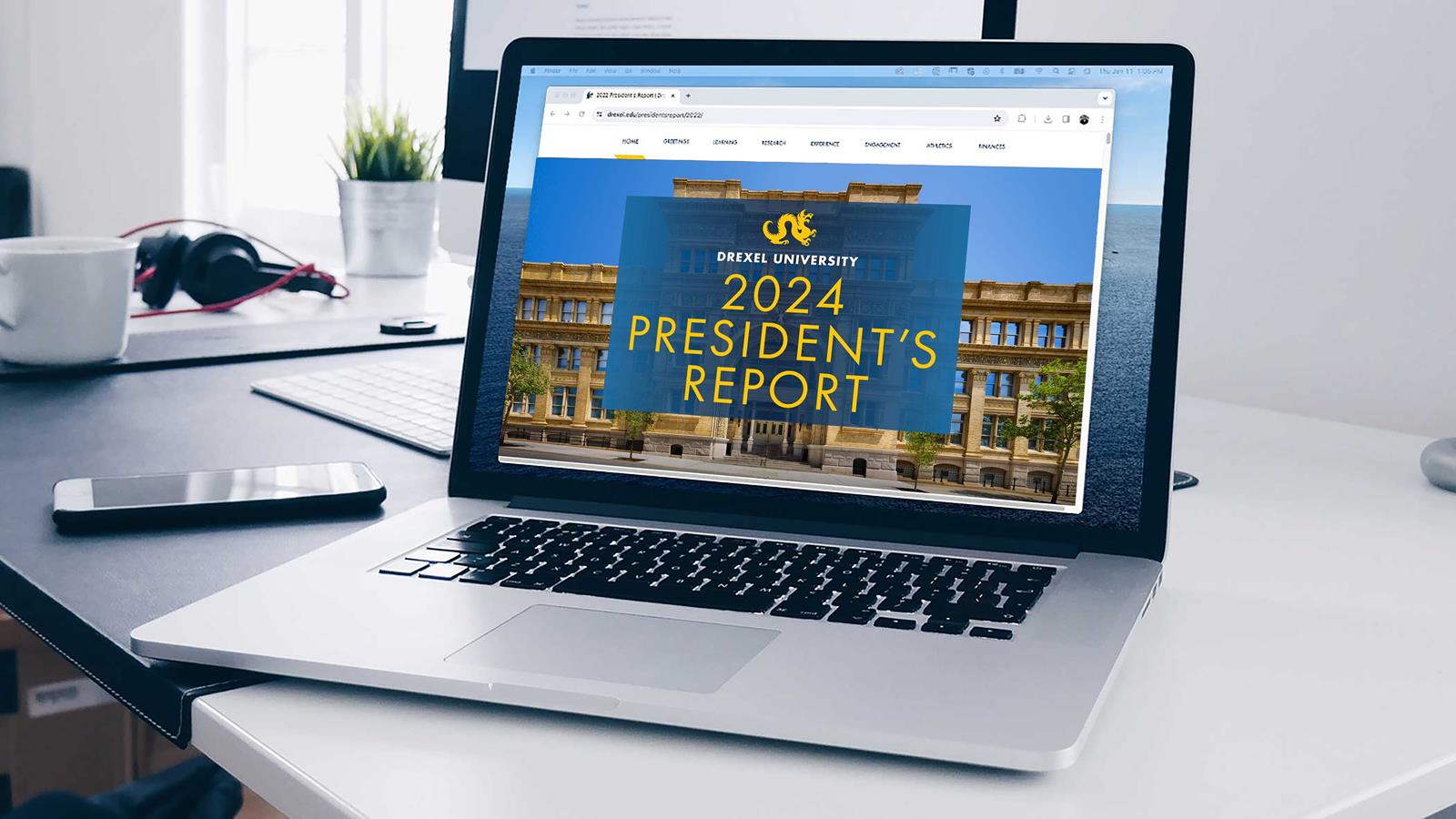 President's Report on laptop screen on desk