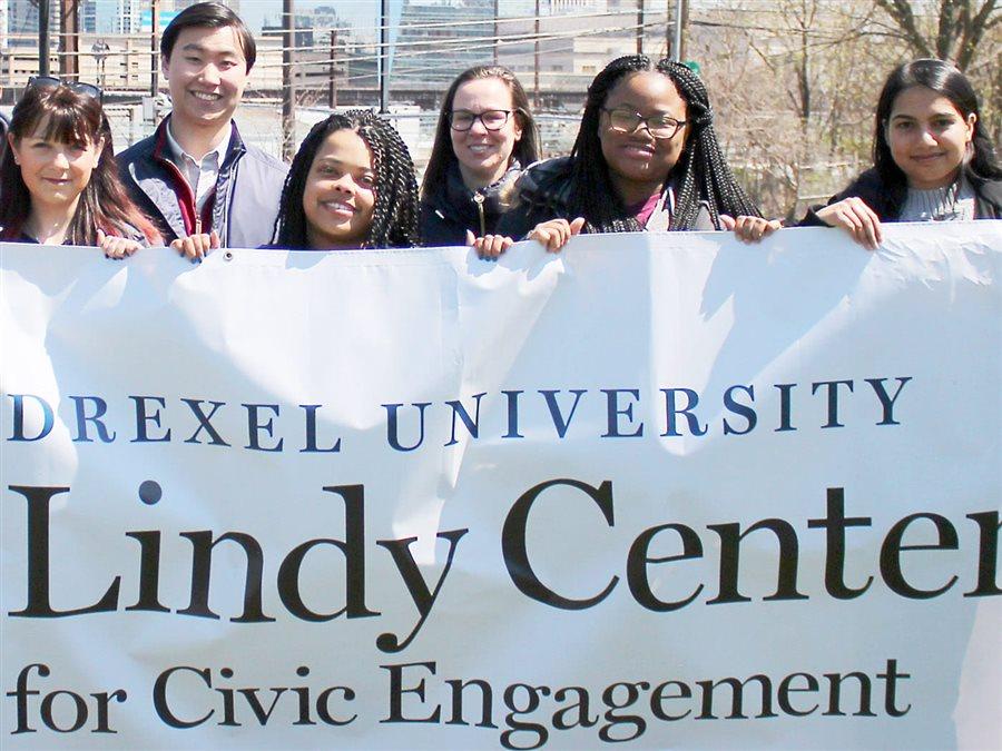 Students holding a sign that says Drexel University Lindy Center for Civic Engagement
