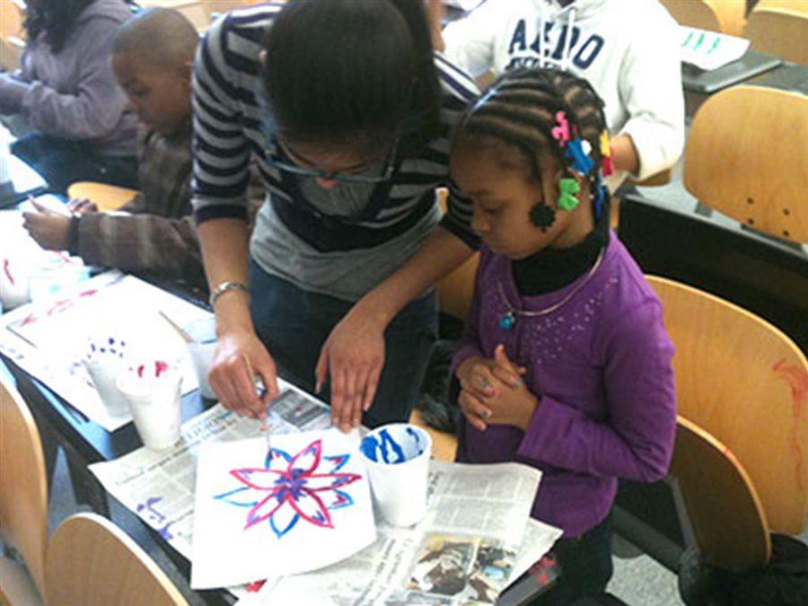 Teacher working with a young student.