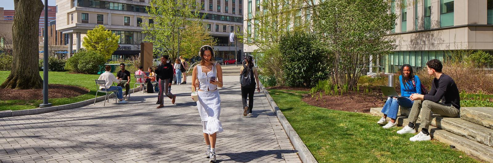 Person wearing headphones walking on Korman woodland walk