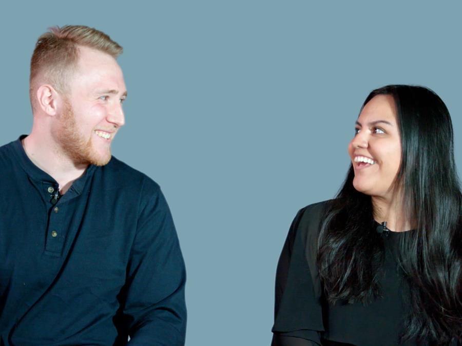Two Drexel students looking at each other and smiling