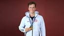 Photo of Justin Best holding 2024 Olympic Gold Medal