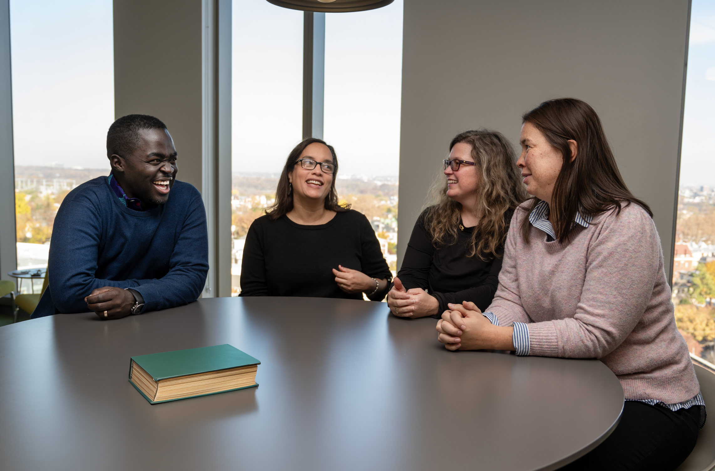 PhD in Couple and Family Therapy sit at round table talking