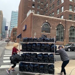 A cart filled with more than 100 bags getting ready to ship to ACE nursing students for the spring term
