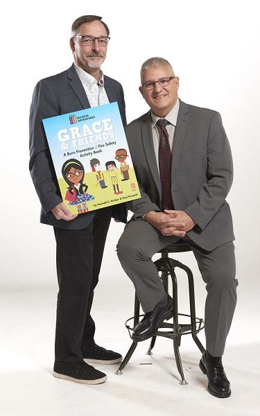 Drexel PA alumni Ken Korber and Paul Possenti holding their co-authored book