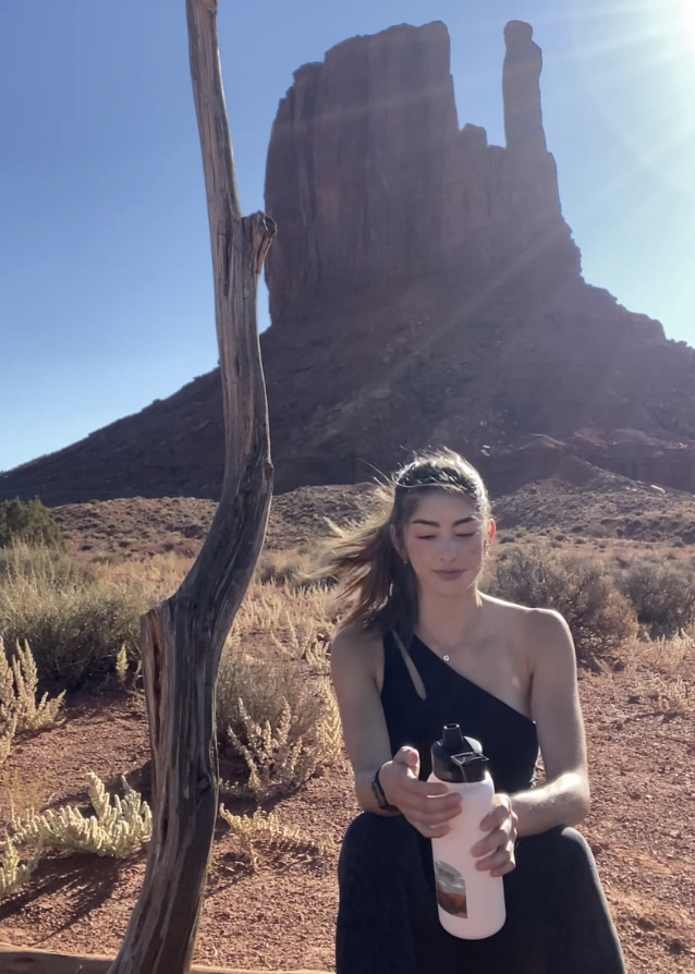 Cassie Job sitting in front of a southwestern butte