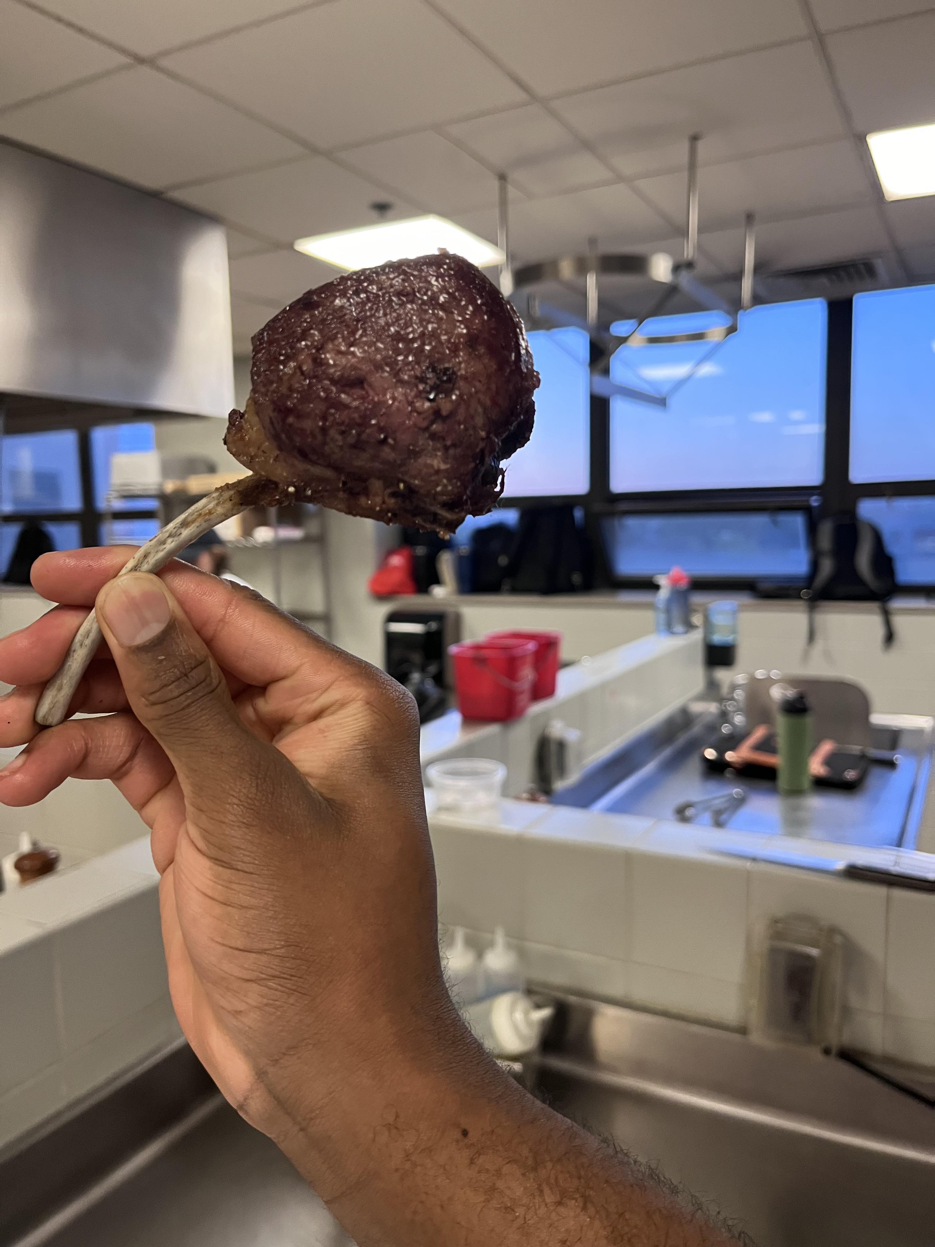 Azarhis Smith holding cooked meat