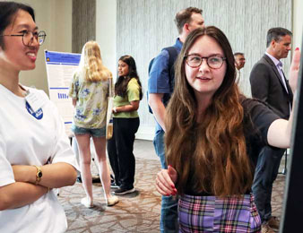 An alumni judge and student engaged in discussion.