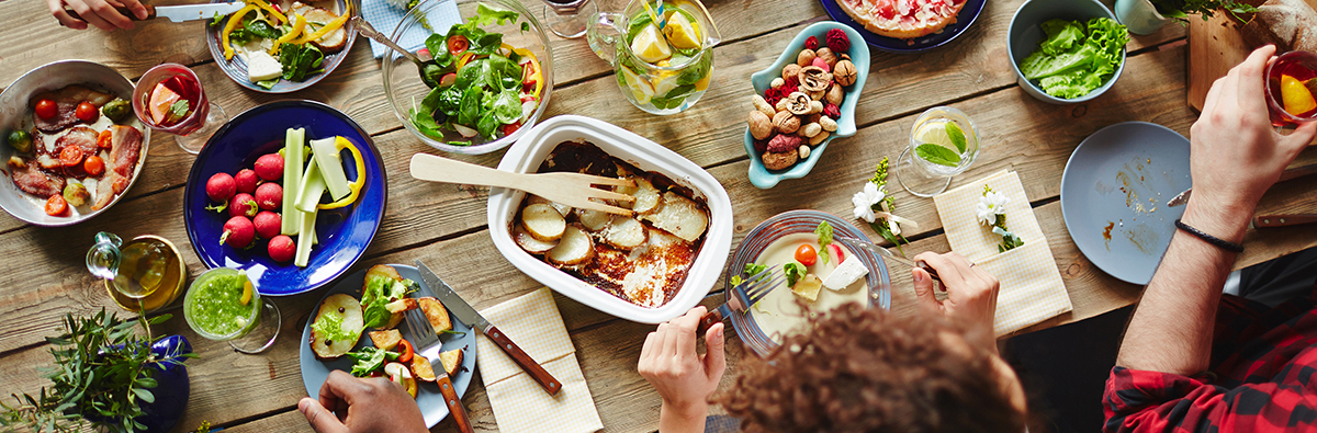 People eating at a table togehter.