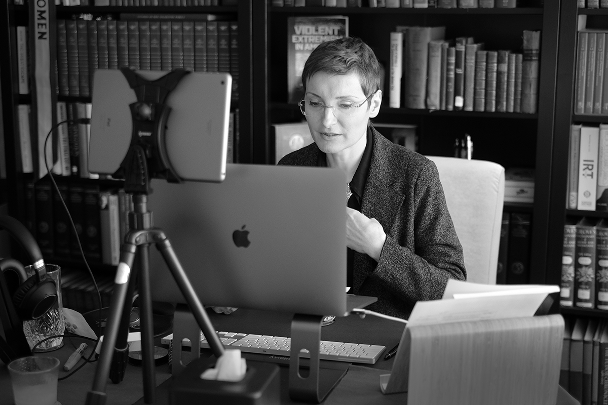 Alina Palimaru sits at a desk in front of a computer