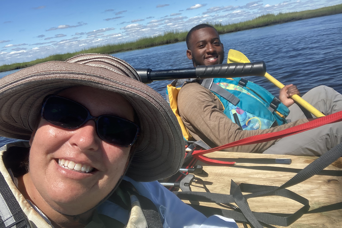 Elizabeth Burke Watson and Daouda Njie on a paddle boat at Tuckahoe Wildlife Management Area in South Jersey