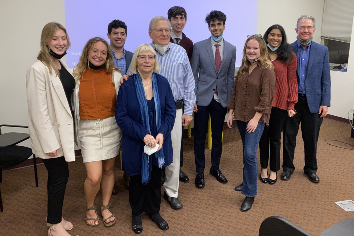 Eight students stand with the Maryanoffs and Chemistry Department Head Joe Foley