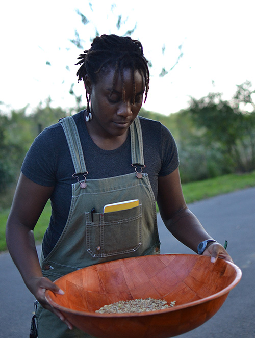 Alexis Wiley prepares to fan shelled peas after cleaning