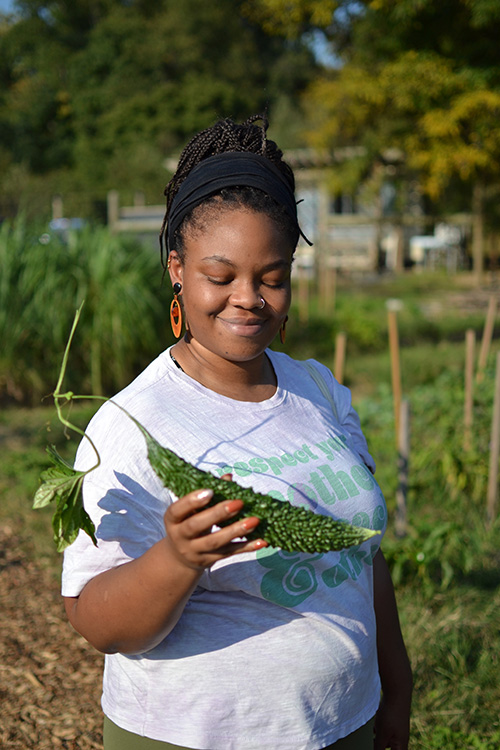 Celeste Sumo admires a bitter melon from the field