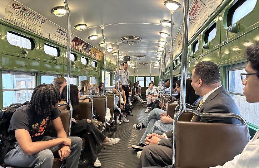 students gathered in a retired SEPTA trolley cart to hear about SEPTA's mission