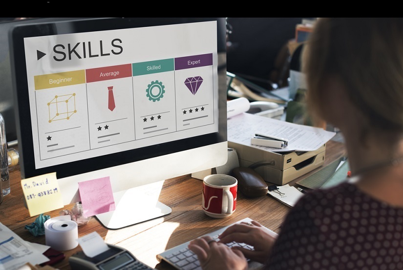 woman viewing skills chart on computer monitor