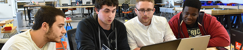 Group of students looking at laptop computer