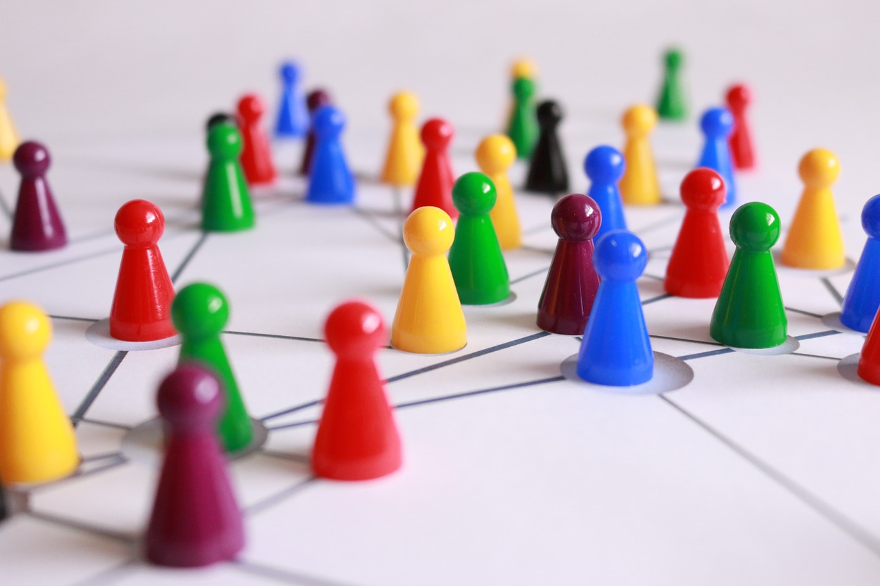 Colorful game pieces on a white board with lines drawn in between.