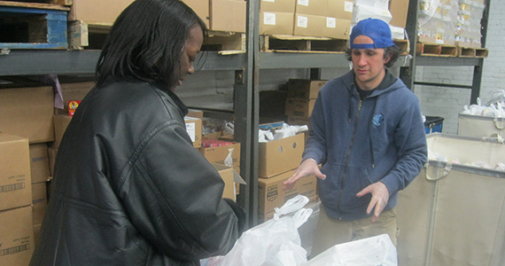 Woman picking up grocery pages at a food pantry