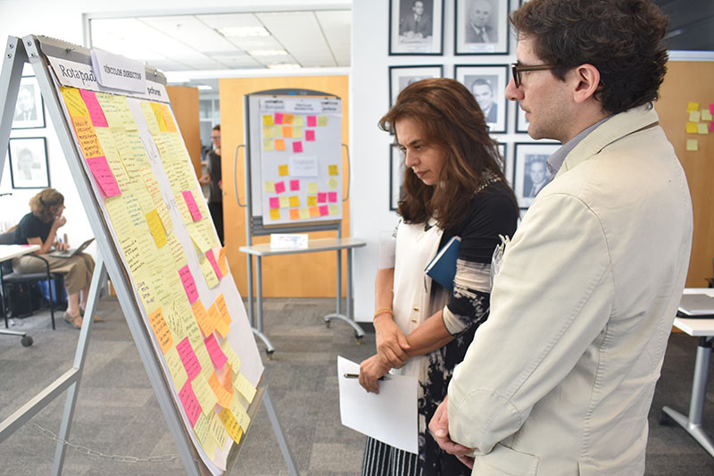 Two participants examining a poster 