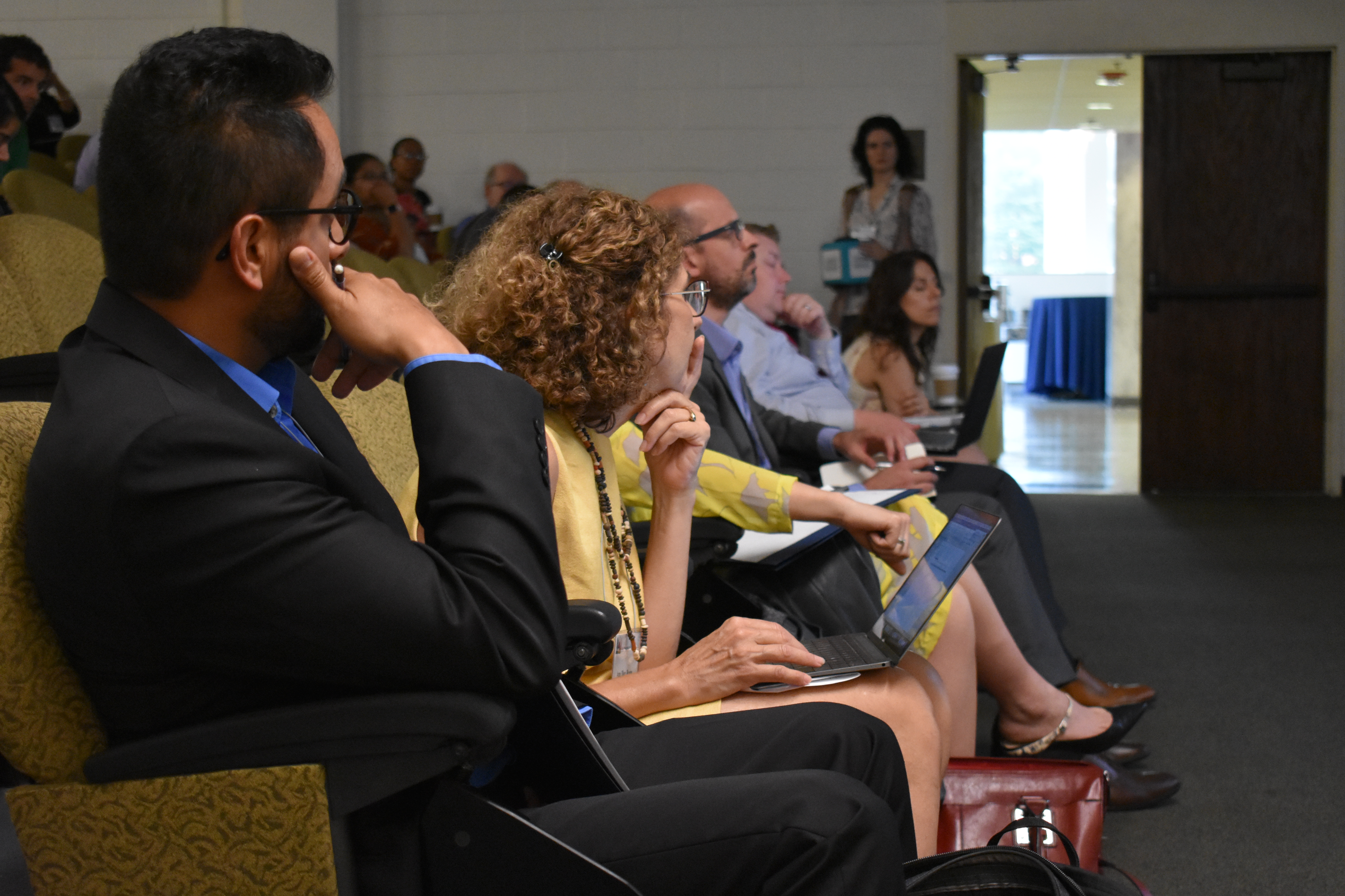 researchers-in-conference-room-listening-to-presentation