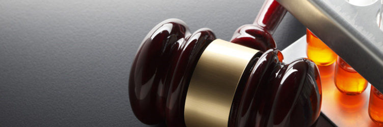 Gavel and testtubes on textured surface.