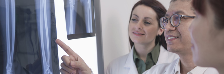 Doctor and residents reviewing x-ray images.
