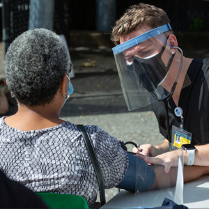 Drexel Medicine student providing medical screenings.