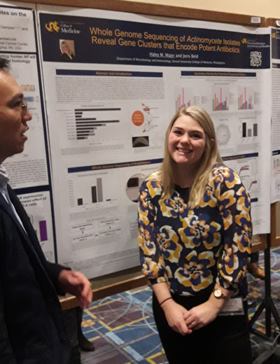 Hayley Majer, CAMP lab member, with her poster at Discovery Day 2019
