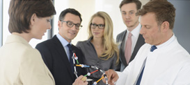 Business colleagues in meeting with a biomedicine scientist.
