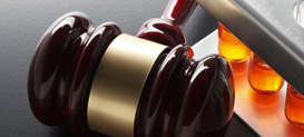 Gavel and testtubes on textured surface.