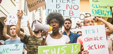 Crowd demonstrating against global warming and plastic pollution, concepts about green ecology and environmental sustainability.