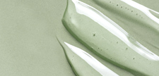 Cosmetic gel texture on green background.