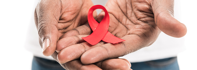 Hands holding red ribbon.