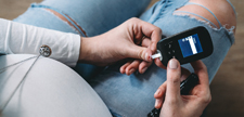 Pregnant woman testing blood sugar.
