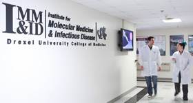 Students walking down the hall at the Institute for Molecular Medicine and Infectious Disease at Drexel University College of Medicine.